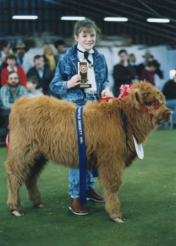 Young girl showing a prize winning Highland Calf